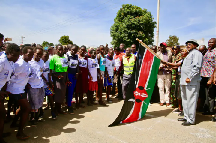 Runners assemble in Kapenguria with the Governor and Ambassador Tegla Loroupe